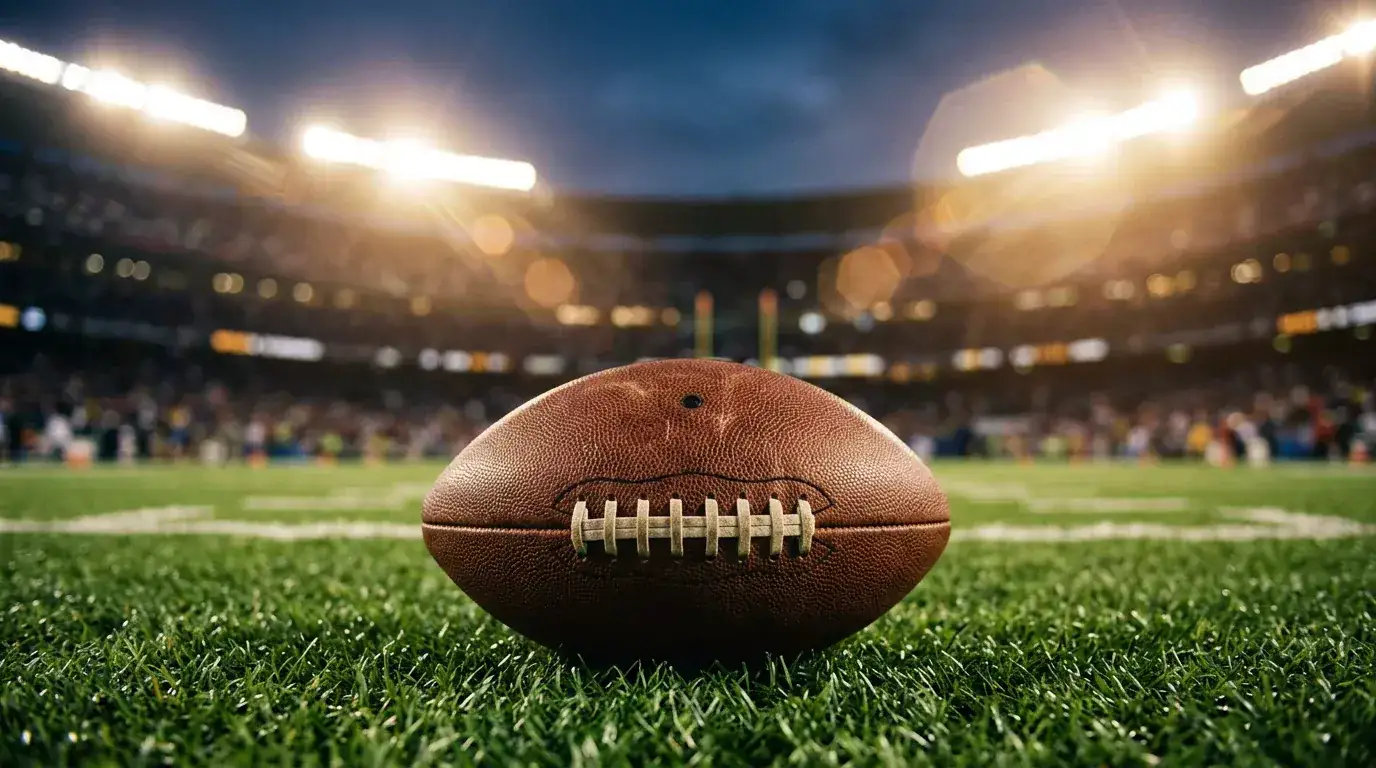 NFL betting odds displayed on a sportsbook screen with a football field in the background
